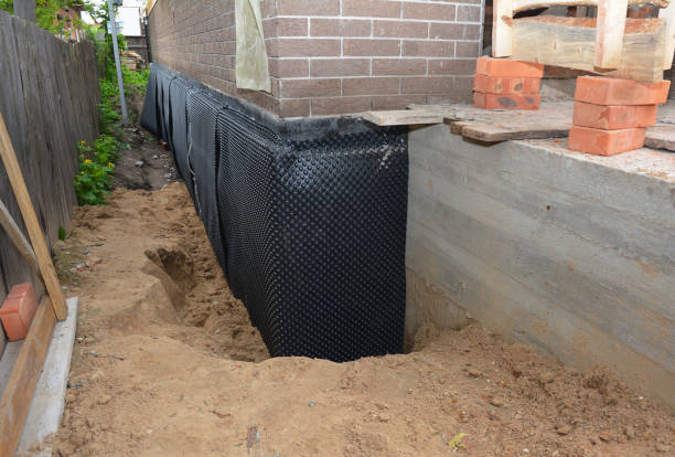 Happy homeowners after waterproofing job in Little Chute